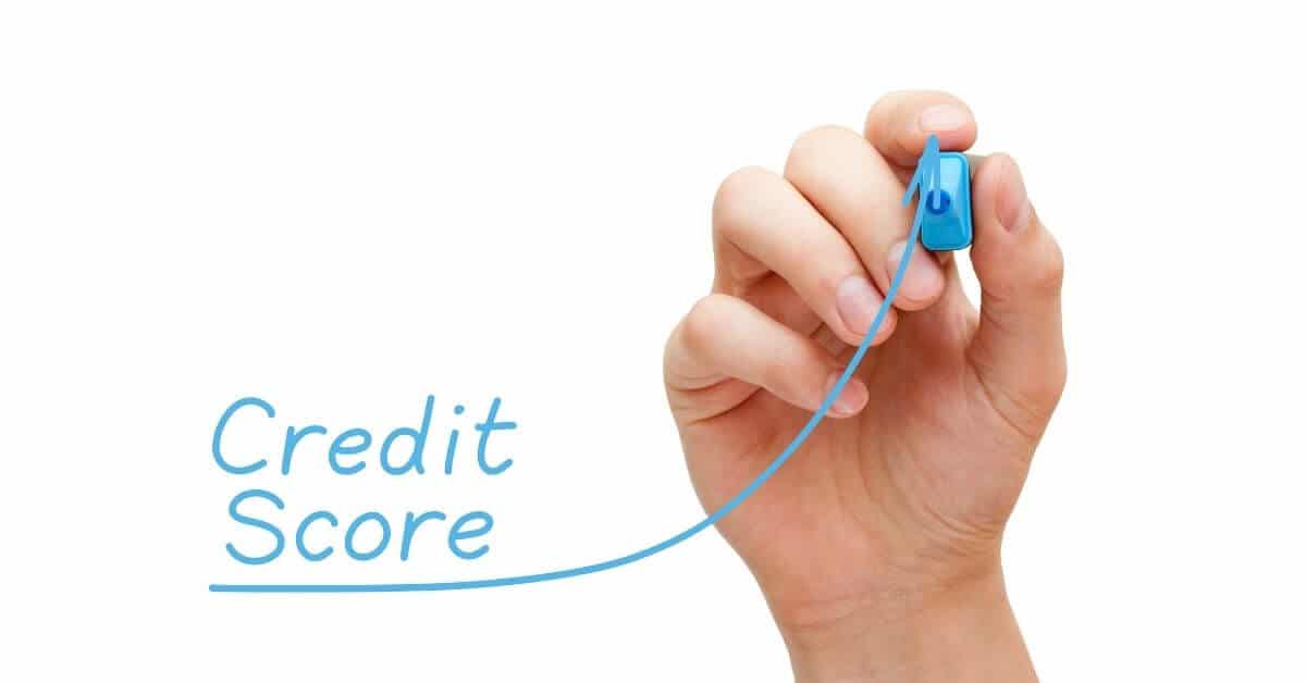 Build credit tips - hand with blue pen that shows graph of credit scores improving